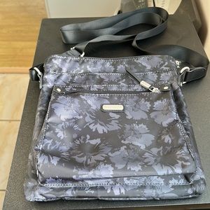 Baggalini black crossbody with gray floral design